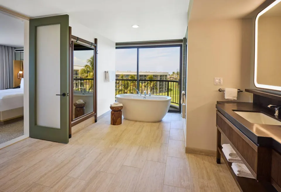 Bathroom with soaking tub and vanity in the Palace Presidential Suite at Hilton Waikoloa Village.
