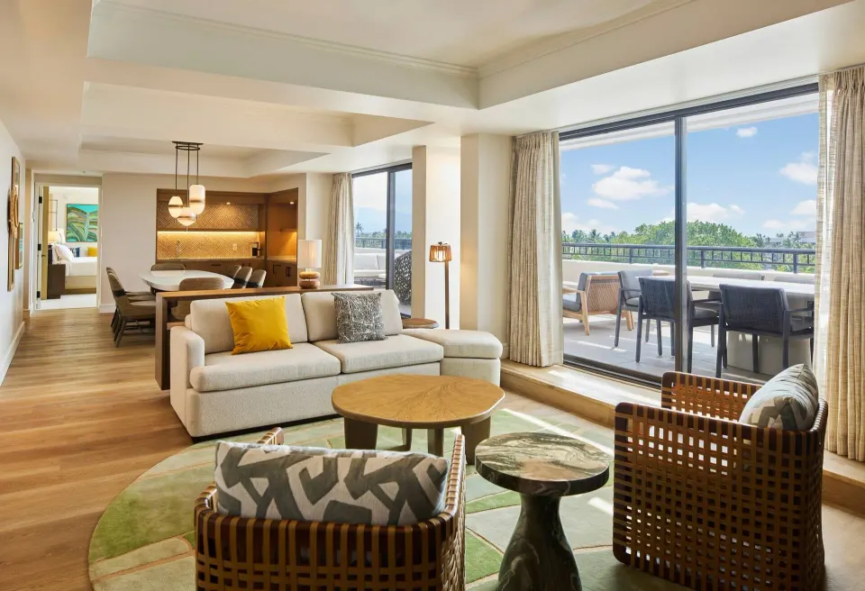 Living and dining room with terrace in the Palace Presidential Suite at Hilton Waikoloa Village.