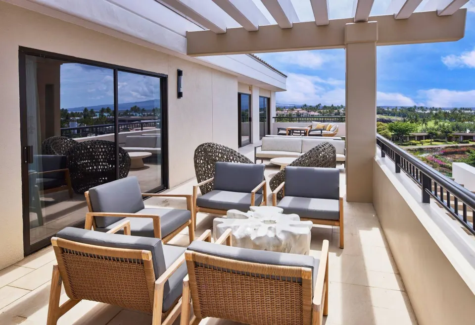 Terrace lounge chairs and ocean view from the Palace Presidential Suite at Hilton Waikoloa Village.