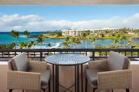 Ocean-view balcony table and chairs in the Presidential Suite at Hilton Waikoloa Village.