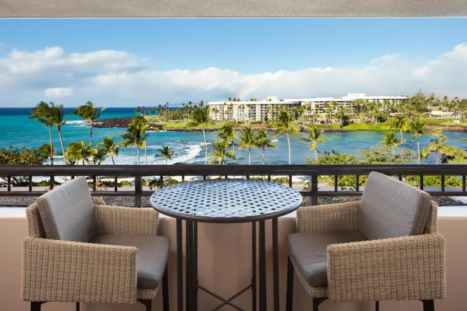 Ocean-view balcony table and chairs in the Presidential Suite at Hilton Waikoloa Village.