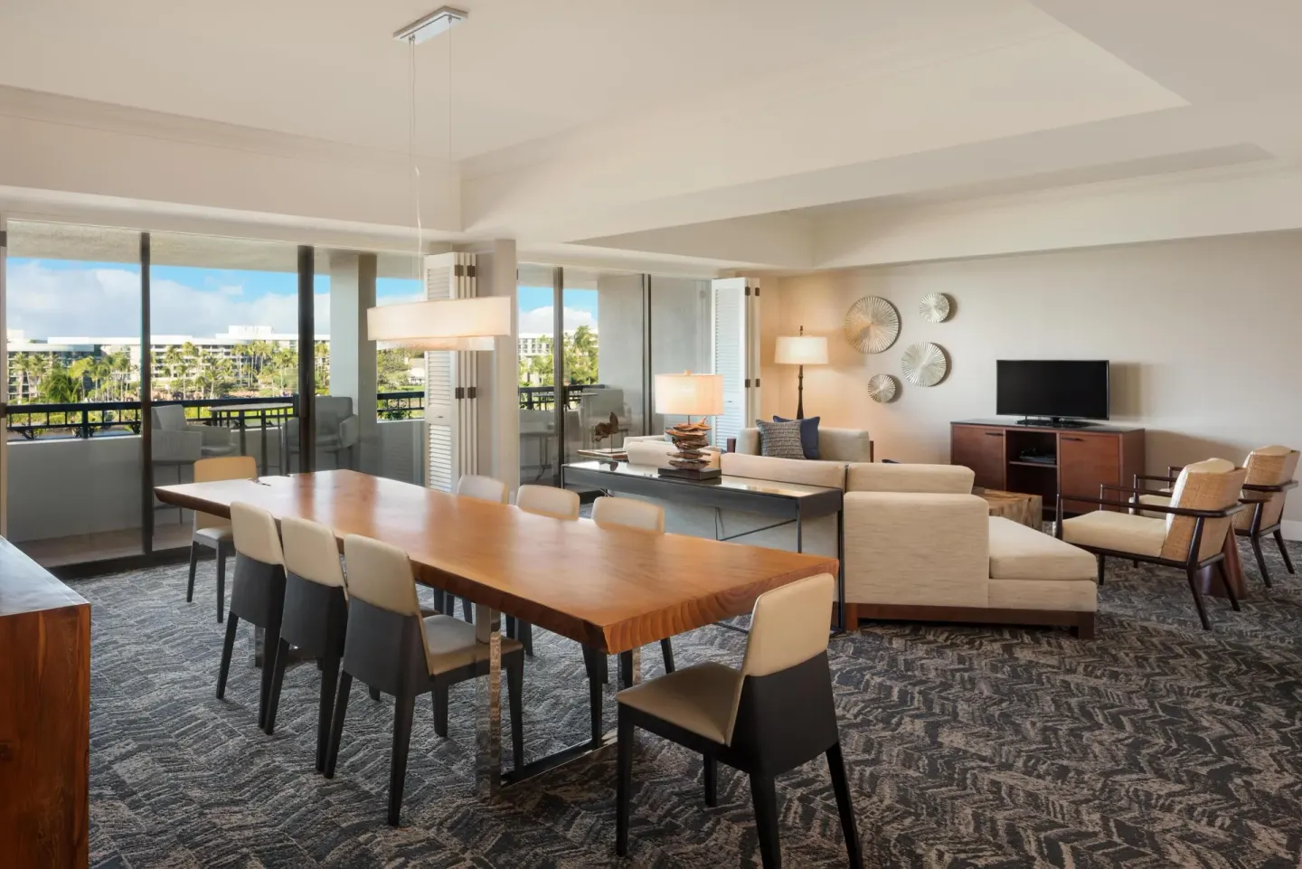 Presidential Suite dining and living area with balcony views at Hilton Waikoloa Village.