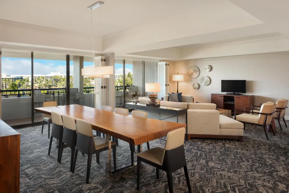 Presidential Suite dining and living area with balcony views at Hilton Waikoloa Village.