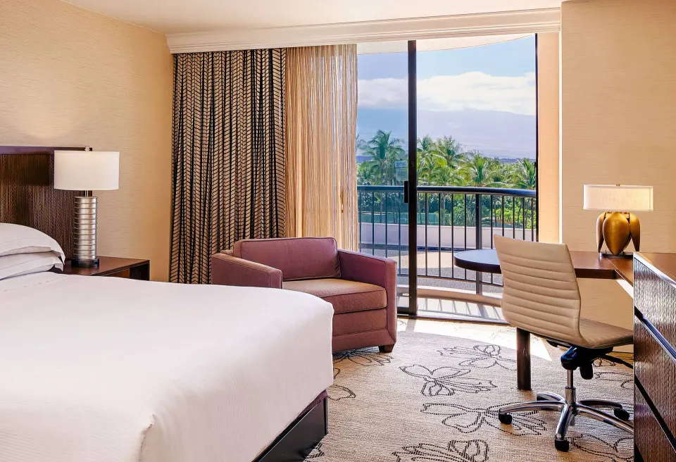Resort View king room seating and balcony at Hilton Waikoloa Village.