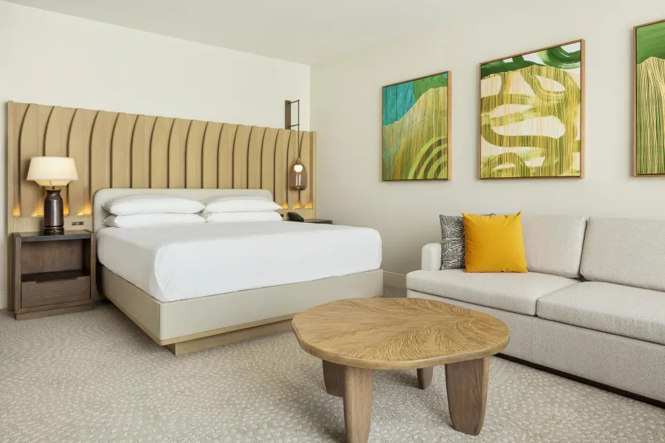 Renovated ocean view guest room with king bed and sofa bed at Hilton Waikoloa Village.