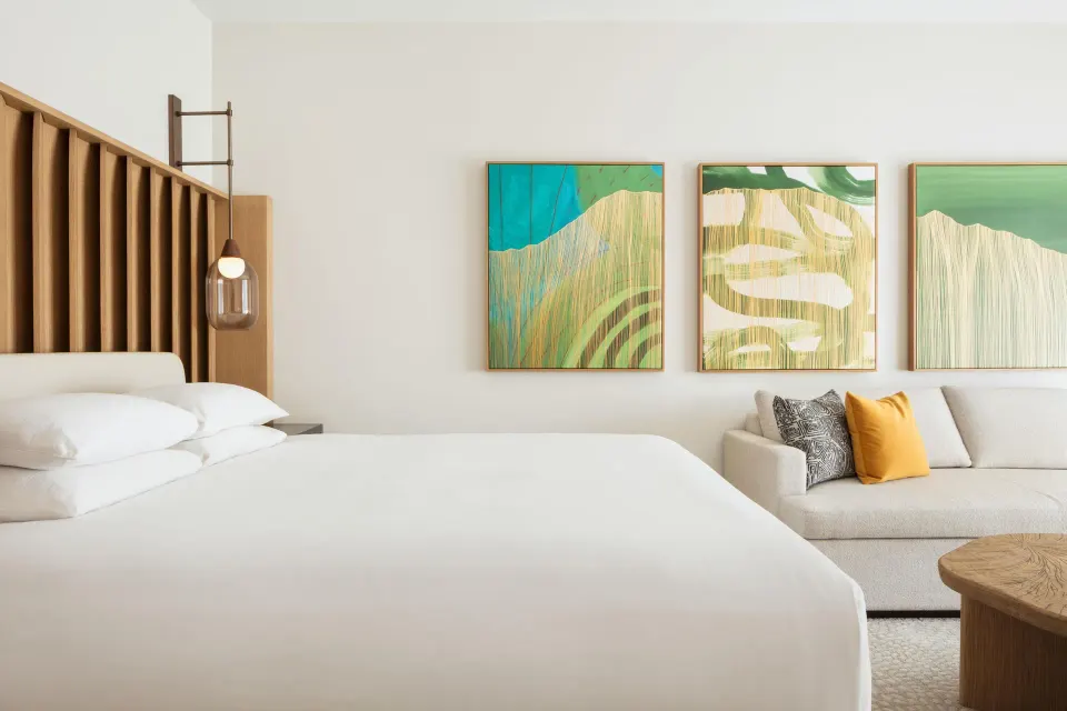 King bed and sofa in an accessible resort-view room at Hilton Waikoloa Village.