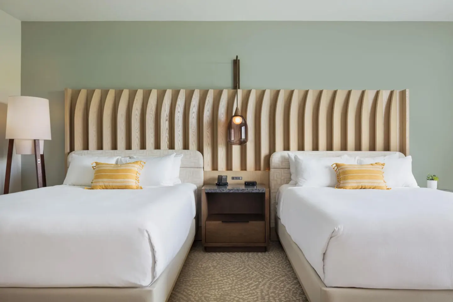 Close view of two queen beds and wood headboard at Hilton Waikoloa Village.