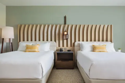 Close view of two queen beds and wood headboard at Hilton Waikoloa Village.