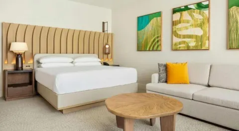 Newly renovated ocean view room with king bed and sofa at Hilton Waikoloa Village.
