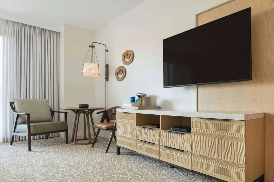 Renovated Ocean View Palace seating area and TV wall at Hilton Waikoloa Village.