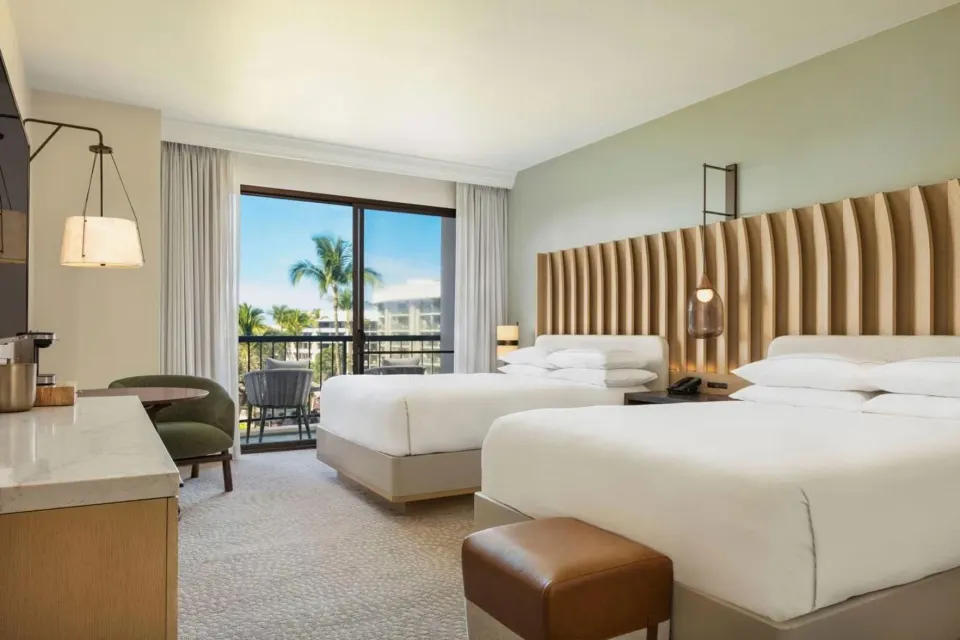Renovated Ocean View Palace room with two beds and balcony at Hilton Waikoloa Village.