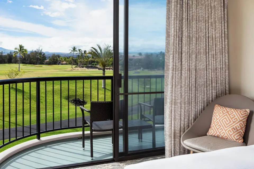 Resort view balcony and guest room seating at Hilton Waikoloa Village.