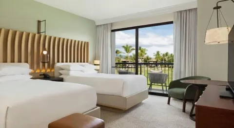 Renovated two-bed guest room with balcony at Hilton Waikoloa Village.