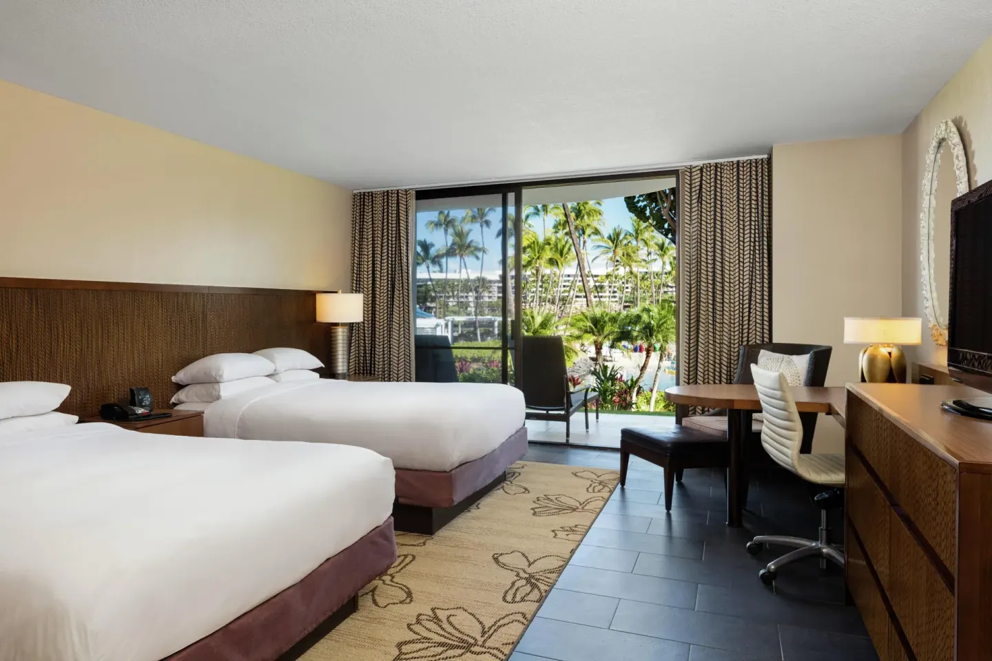 Resort view guest room with two beds and balcony at Hilton Waikoloa Village.