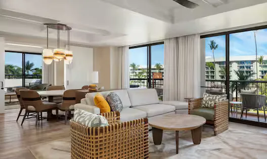 Room with resort view living and dining area at Hilton Waikoloa Village.