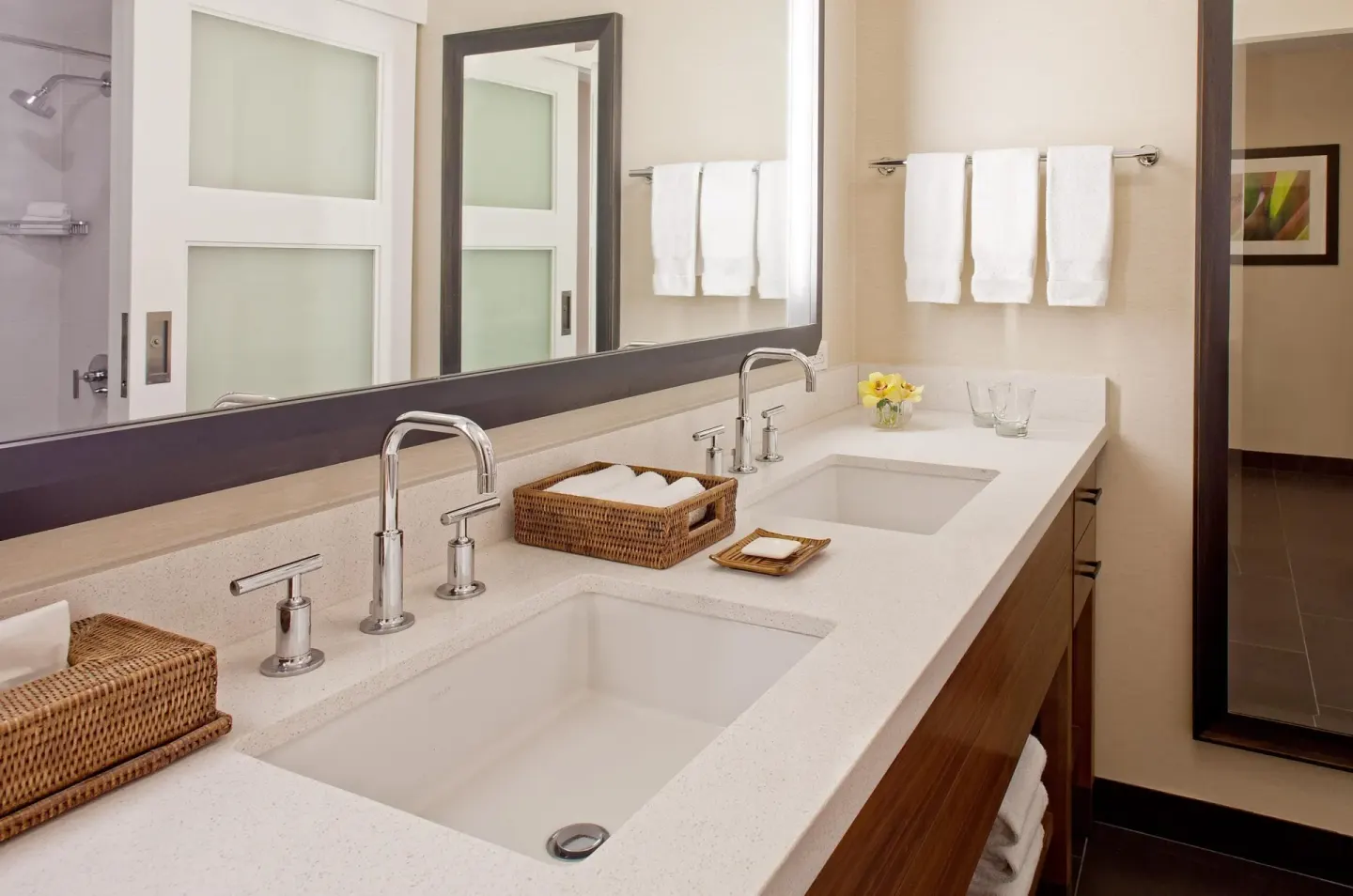 Double-sink bathroom vanity with large mirror in a room at Hilton Waikoloa Village.