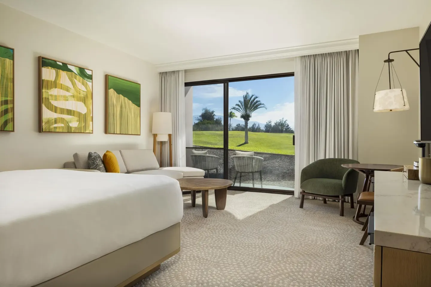 Renovated resort-view guest room with king bed and sofa bed at Hilton Waikoloa Village.