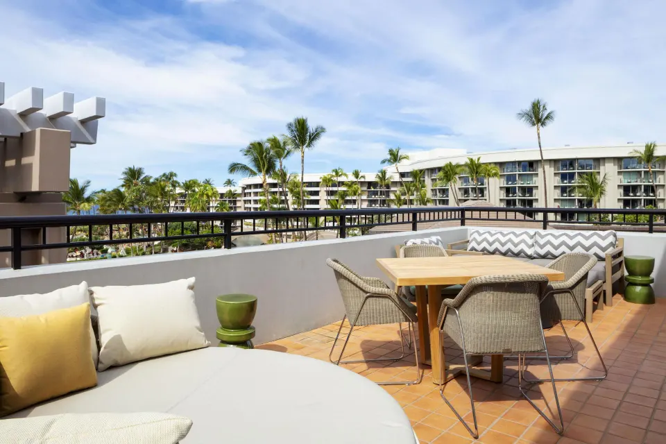 Royal Suite furnished balcony with table seating at Hilton Waikoloa Village.