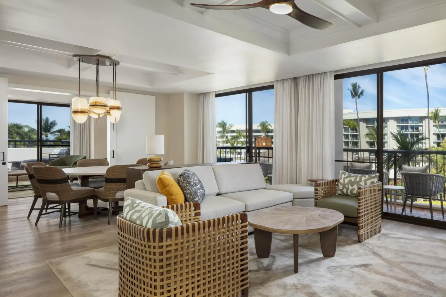 Royal Suite open living and dining area with balconies at Hilton Waikoloa Village.