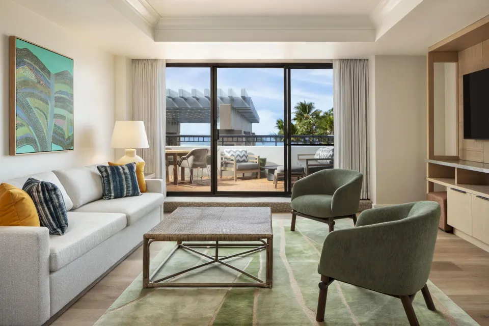 Royal Suite living room with balcony seating at Hilton Waikoloa Village.
