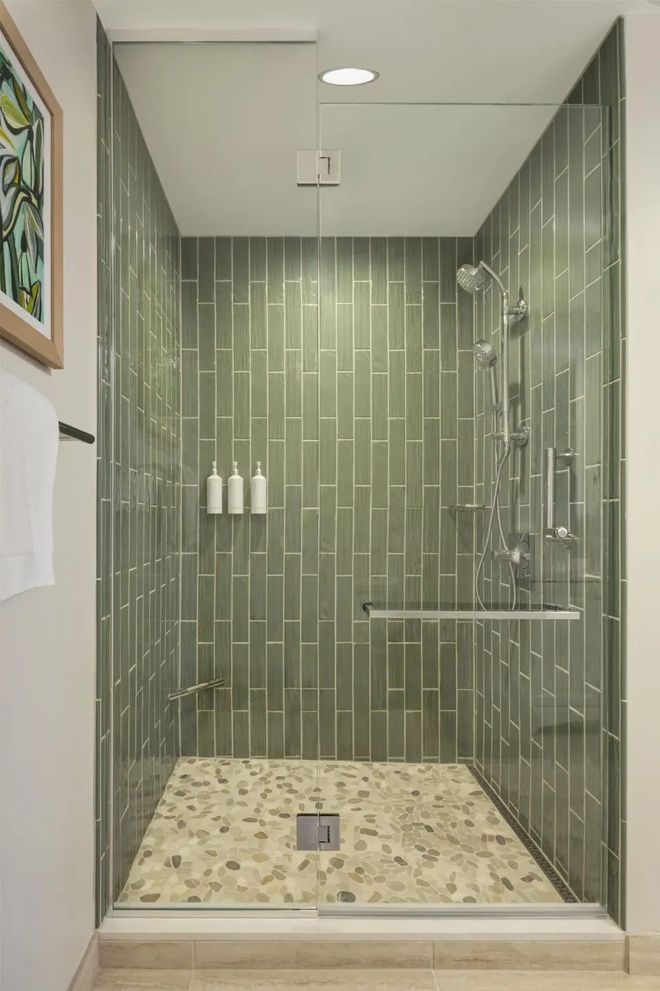 Glass-enclosed tiled shower in an ocean view one-bedroom suite at Hilton Waikoloa Village.