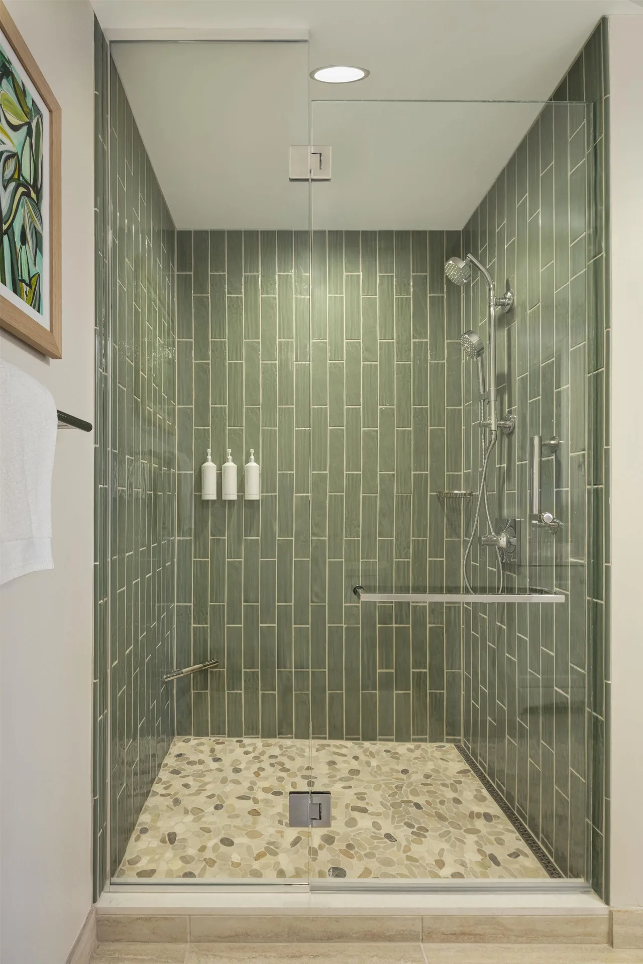 Glass-enclosed tiled shower in an ocean view one-bedroom suite at Hilton Waikoloa Village.