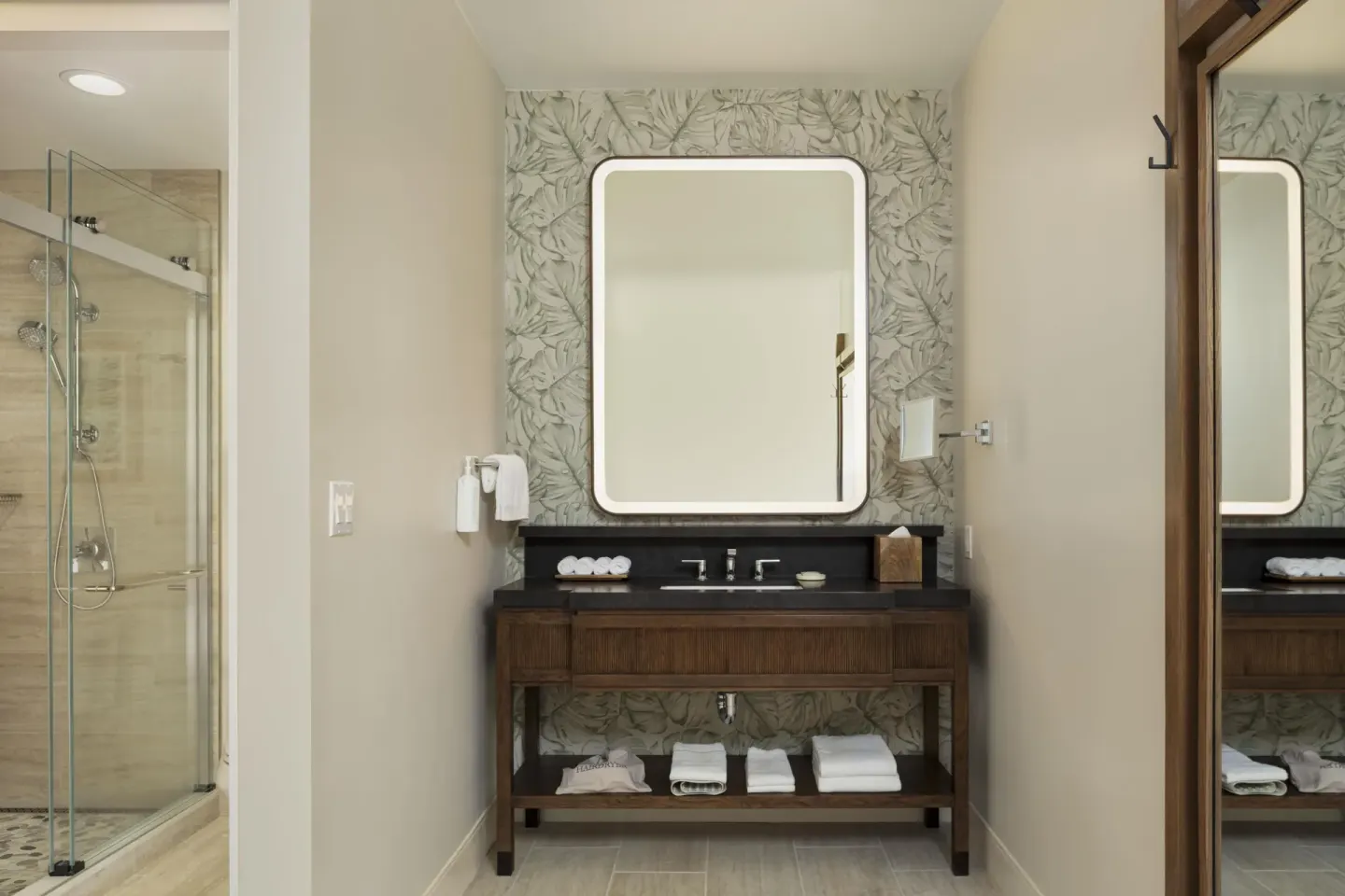 Accessible suite bathroom vanity and glass shower at Hilton Waikoloa Village.