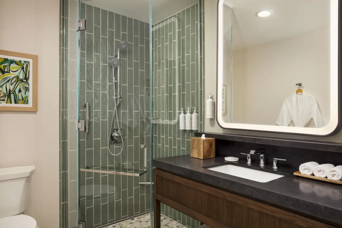 Accessible suite shower and vanity with robe at Hilton Waikoloa Village.