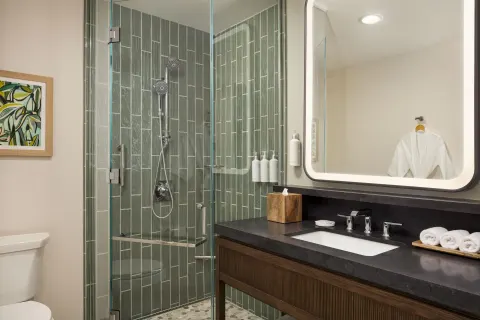 Accessible suite shower and vanity with robe at Hilton Waikoloa Village.