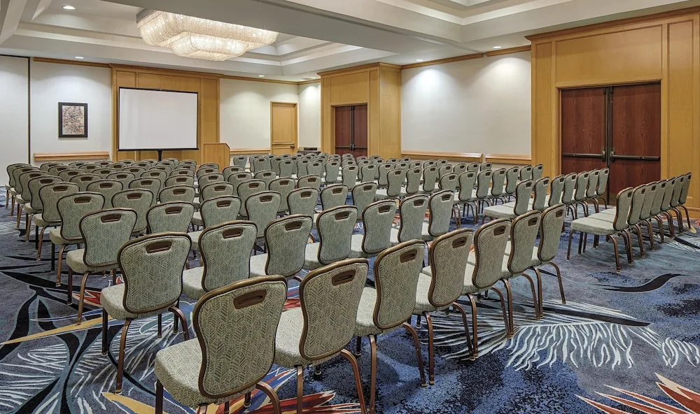 Meeting room with theater-style chairs and screen at Hilton Waikoloa Village.