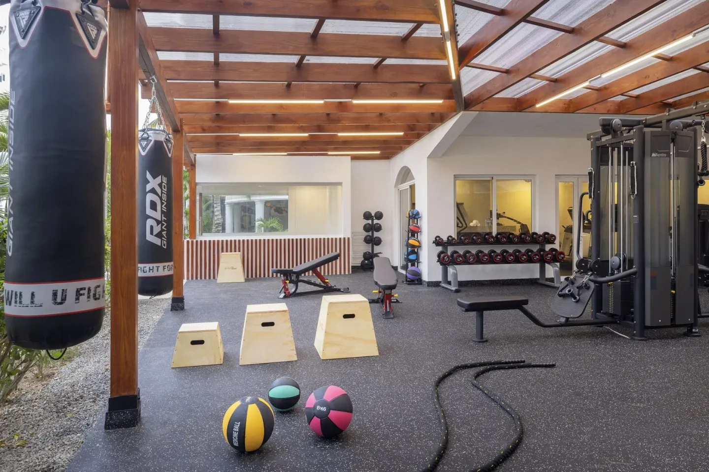 Open-air fitness area with punching bags and weights at HM Alma de Bayahibe.