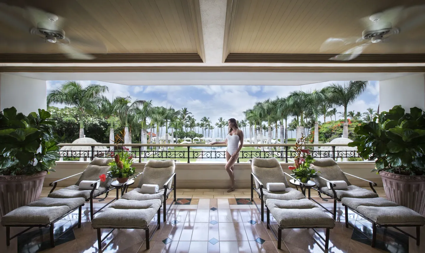 Covered relaxation terrace with cushioned loungers at Ho‘olei Villas at Grand Wailea.