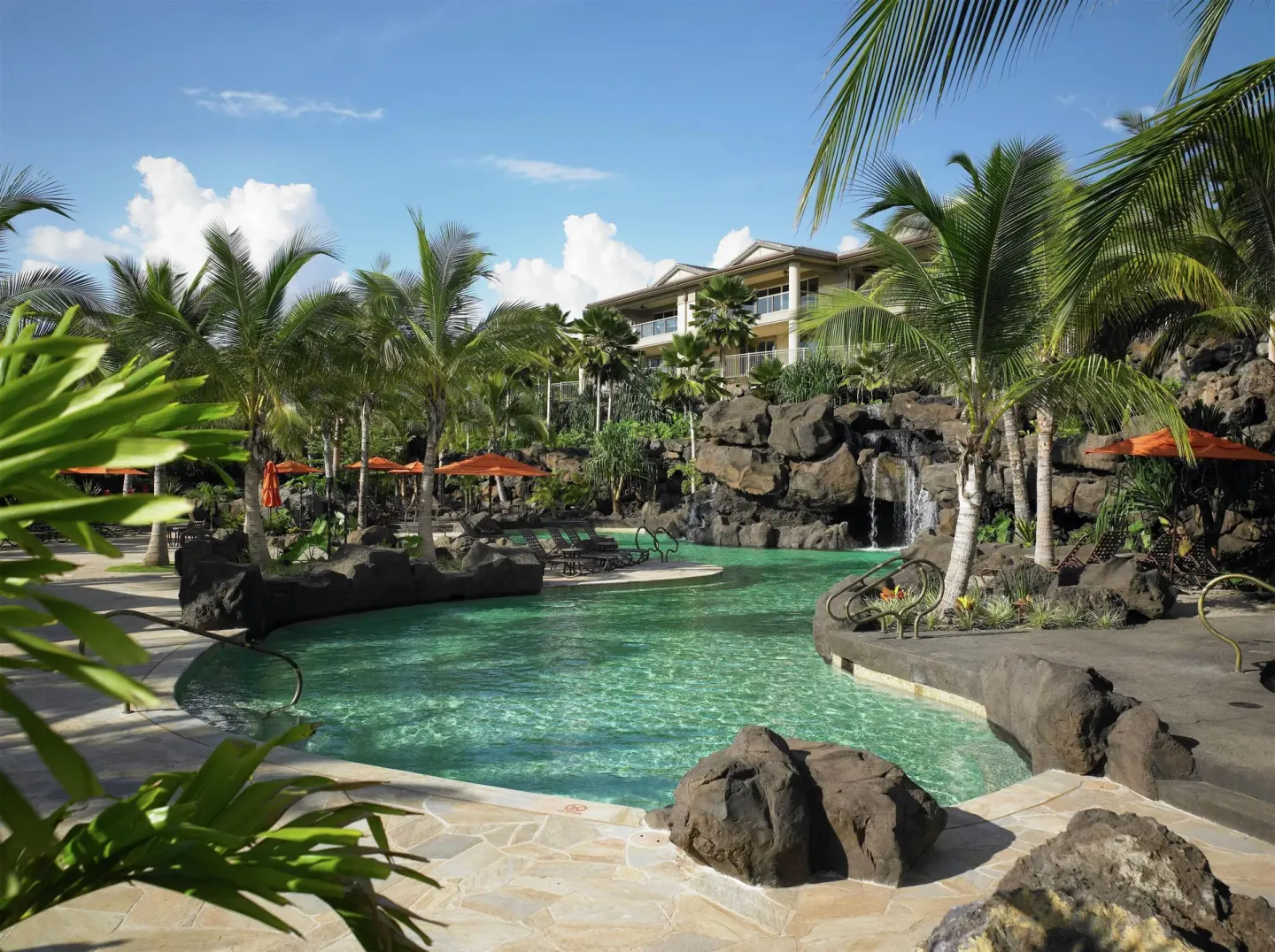 Lagoon-style pool with palms and waterfalls at Ho‘olei Villas at Grand Wailea.