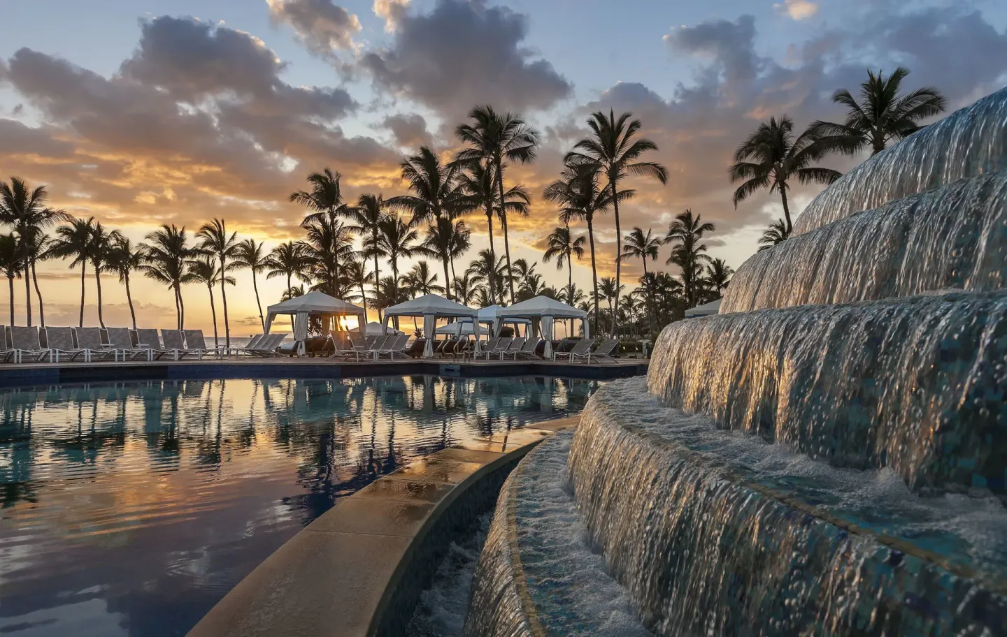 Tiered waterfall beside the resort pool at sunset at Ho‘olei Villas at Grand Wailea.