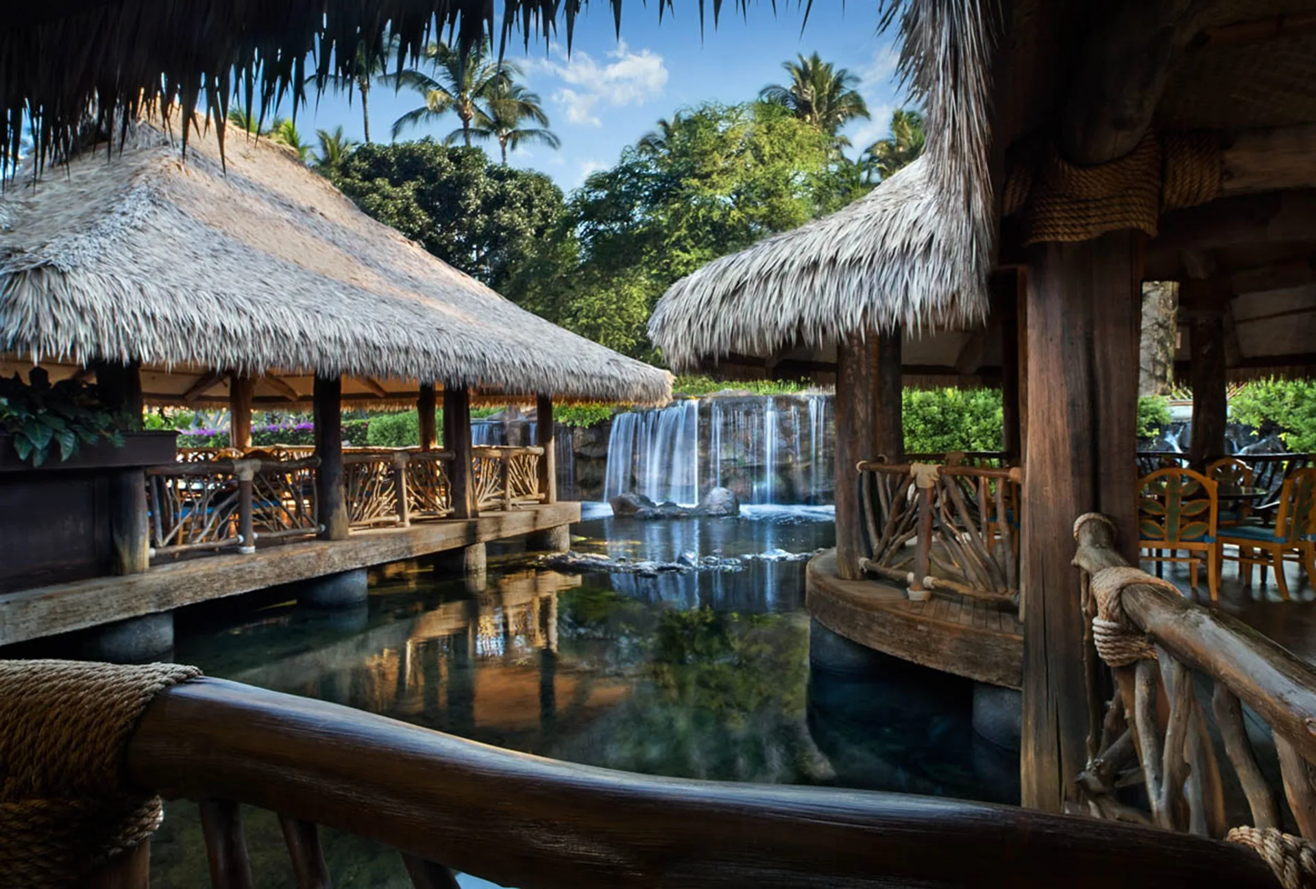 Thatched pavilions and a waterfall over a lagoon at Ho‘olei Villas at Grand Wailea.