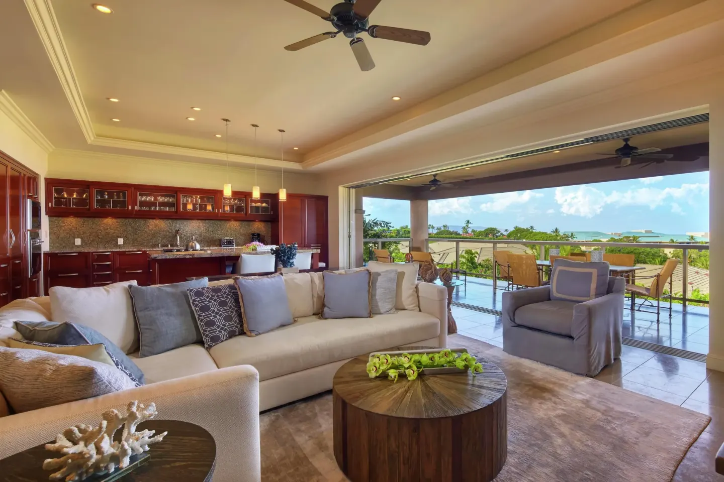 Spacious villa living room with kitchen and lanai at Ho‘olei Villas at Grand Wailea.