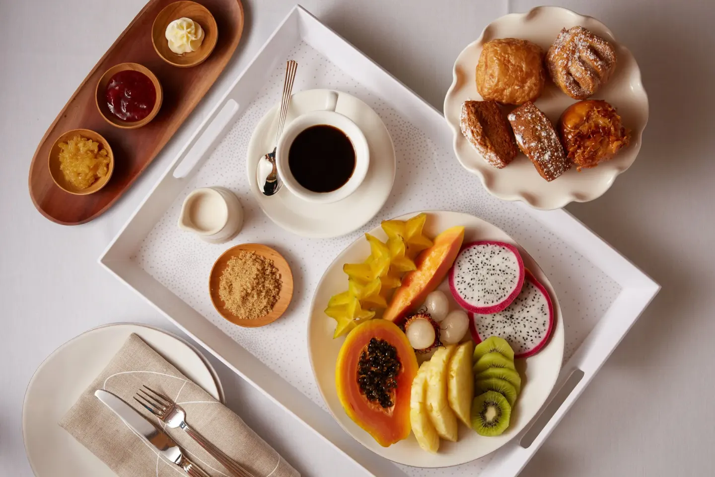 Breakfast tray with tropical fruit, pastries, coffee, and condiments at Ho‘olei Villas at Grand Wailea.