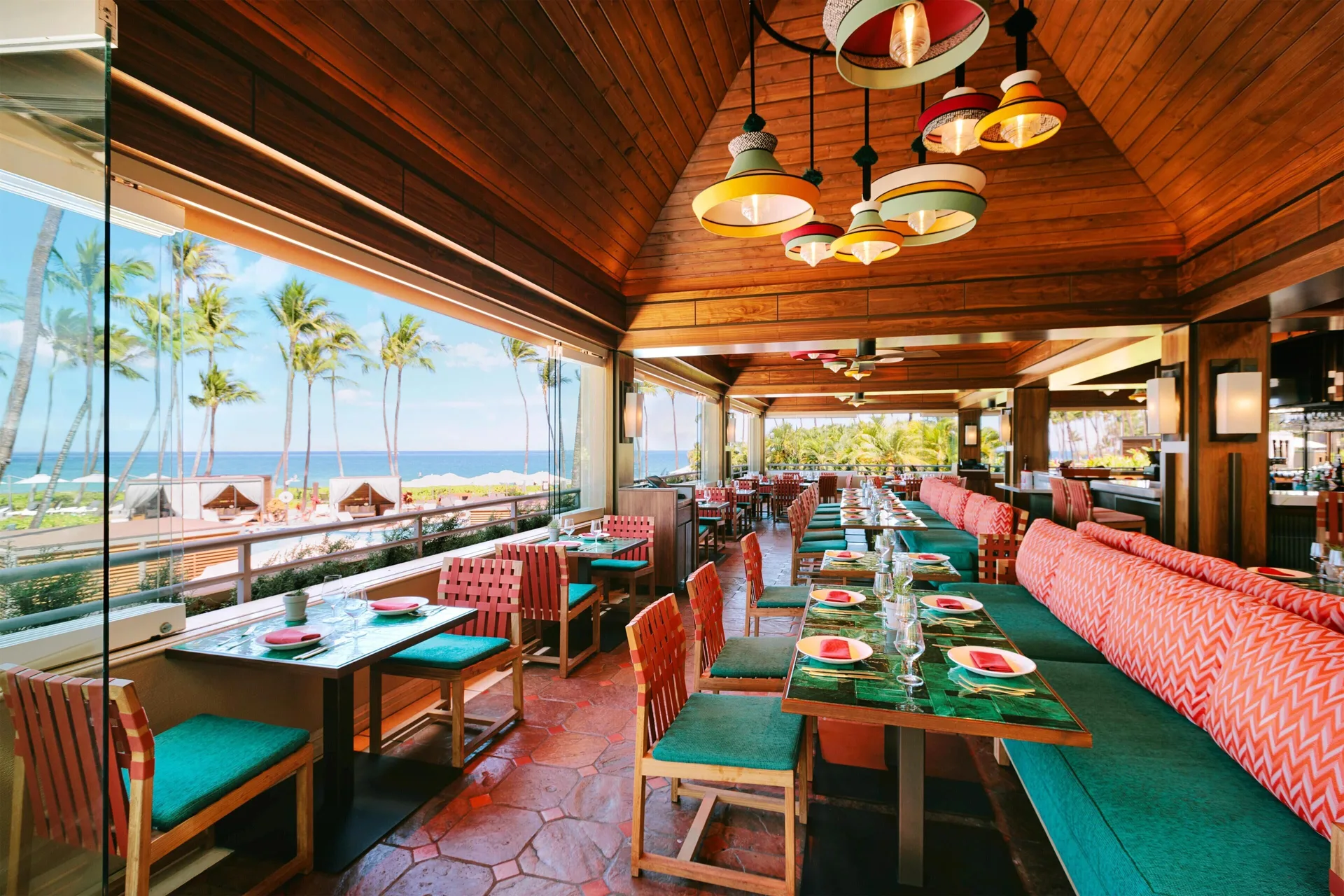 Ocean-view restaurant with colorful seating at Ho‘olei Villas at Grand Wailea.