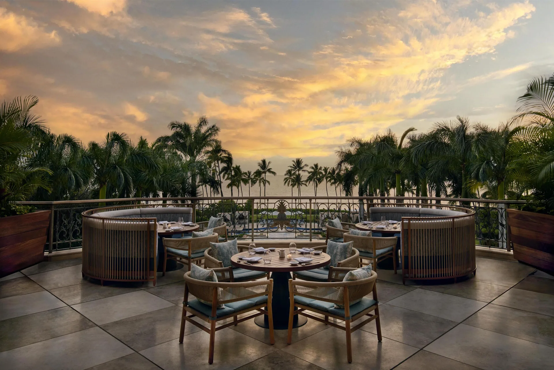 Terrace dining setup at sunset at Ho‘olei Villas at Grand Wailea.