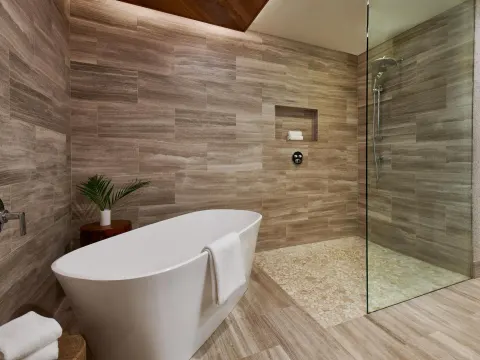 Deluxe villa bathroom with soaking tub and glass shower at Ho‘olei Villas at Grand Wailea.