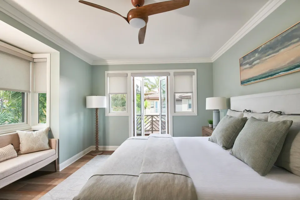 Light-filled bedroom with king bed and balcony doors at Ho‘olei Villas at Grand Wailea.