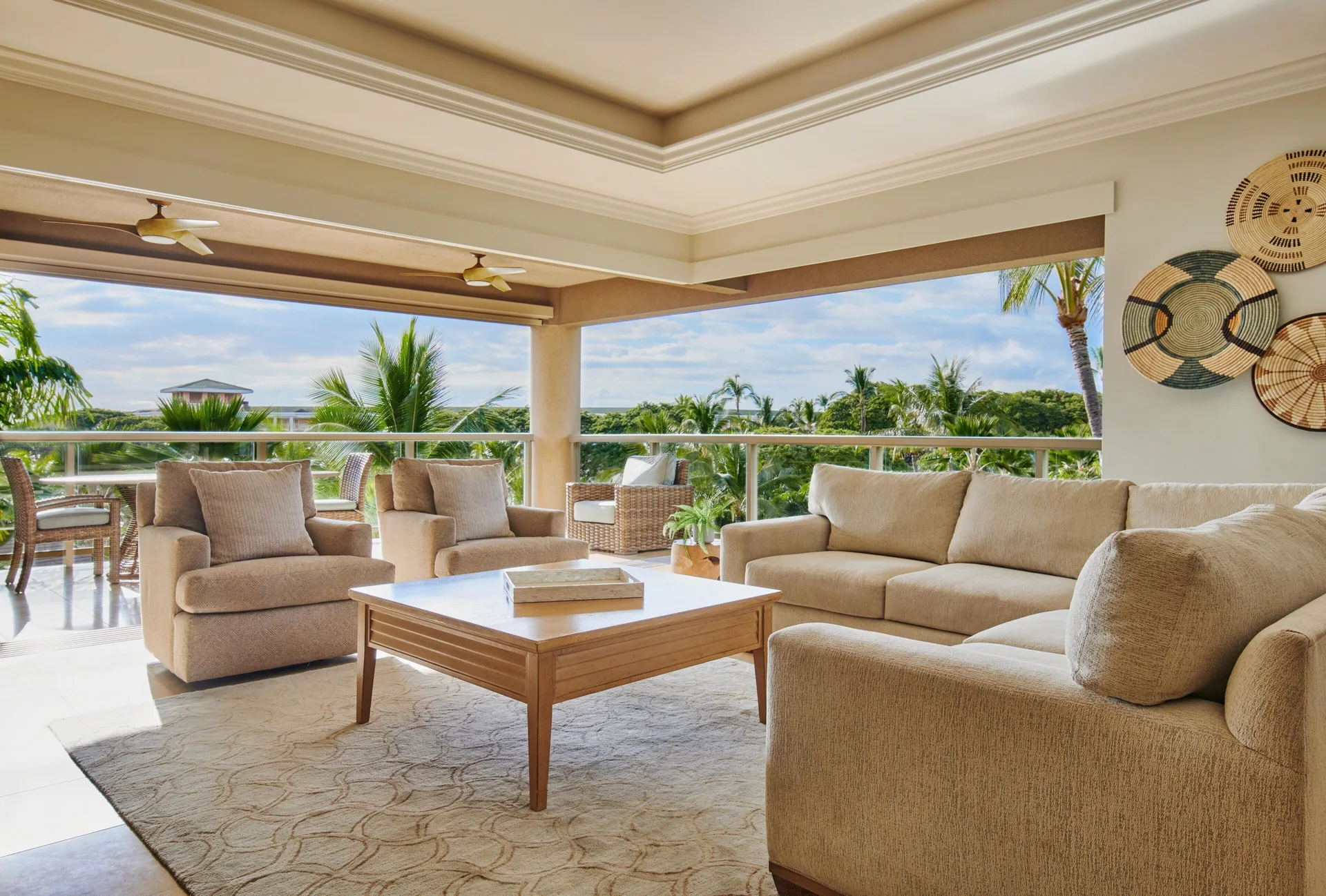 Lanai living room with garden and ocean glimpses at Ho‘olei Villas at Grand Wailea.