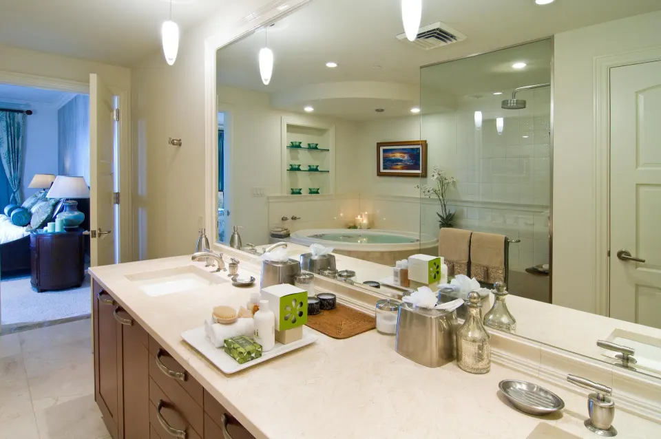 Villa bathroom vanity with bath amenities and glass shower at Ho‘olei Villas at Grand Wailea.