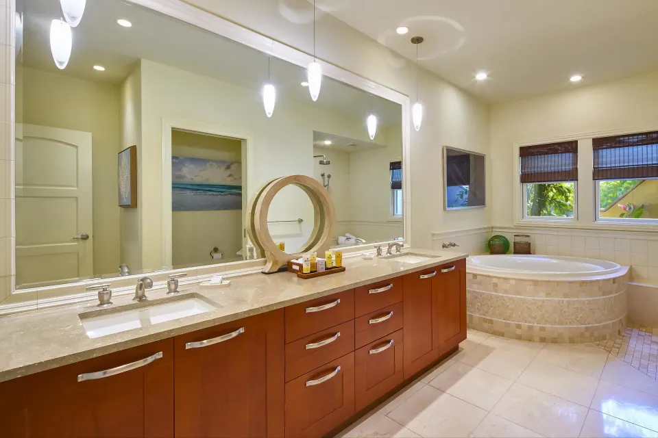Luxury villa bathroom with double vanity and round soaking tub at Ho‘olei Villas at Grand Wailea.