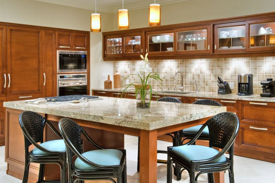 Luxury villa kitchen with granite island and bar seating at Ho‘olei Villas at Grand Wailea.