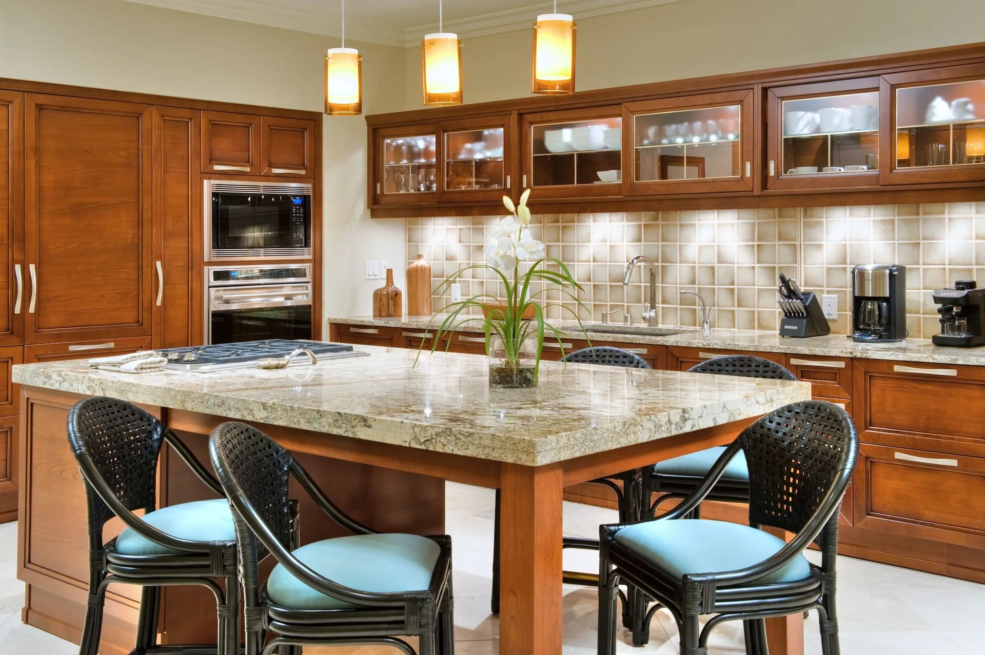 Luxury villa kitchen with granite island and bar seating at Ho‘olei Villas at Grand Wailea.
