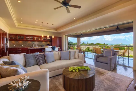 Luxury villa living room with open kitchen, lanai, and ocean view at Ho‘olei Villas at Grand Wailea.