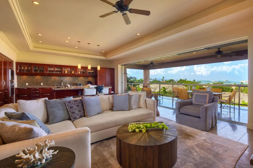 Luxury villa living room with open kitchen, lanai, and ocean view at Ho‘olei Villas at Grand Wailea.