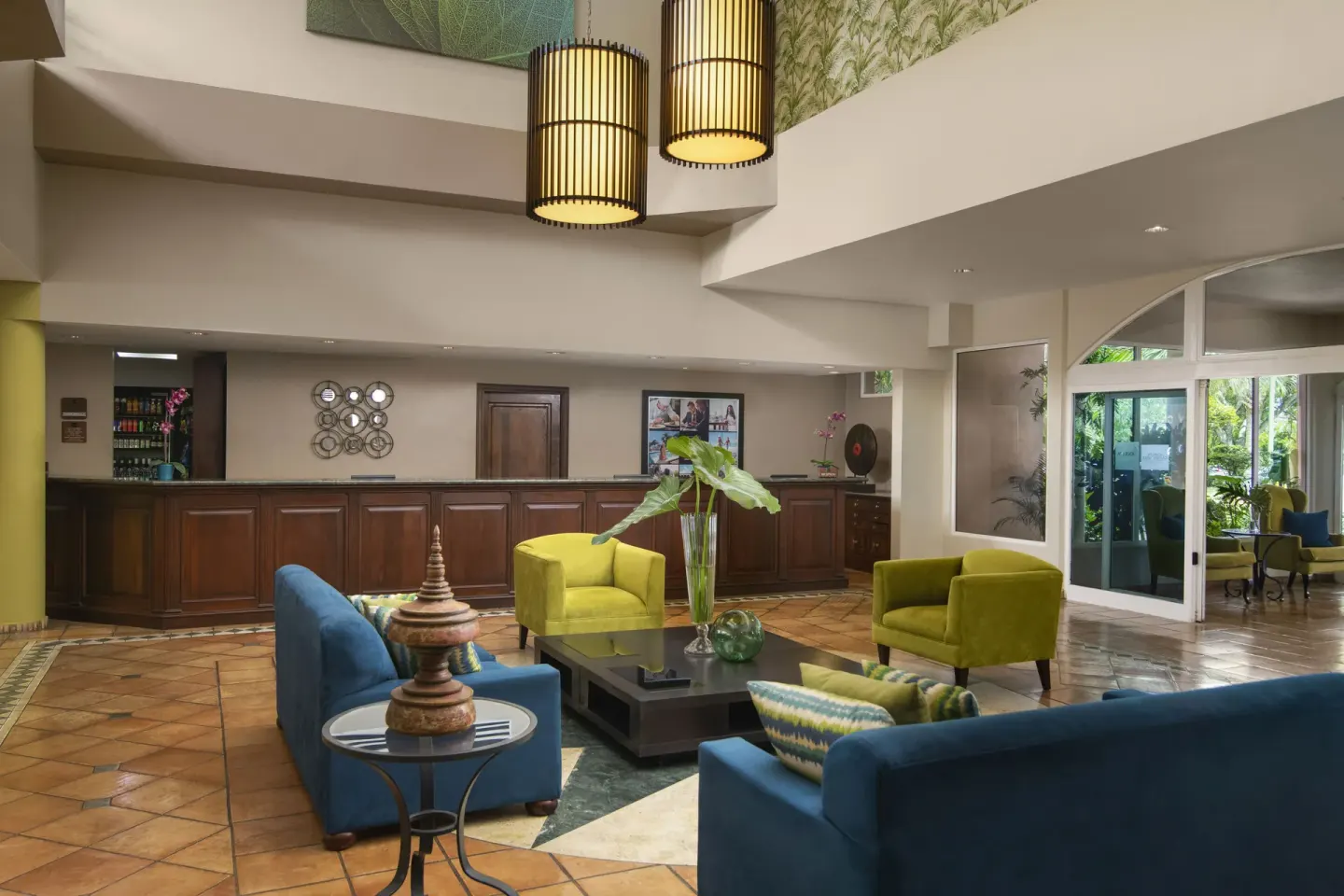 Colorful lobby seating by reception at Hodelpa Garden Suites Golf & Convention Center.