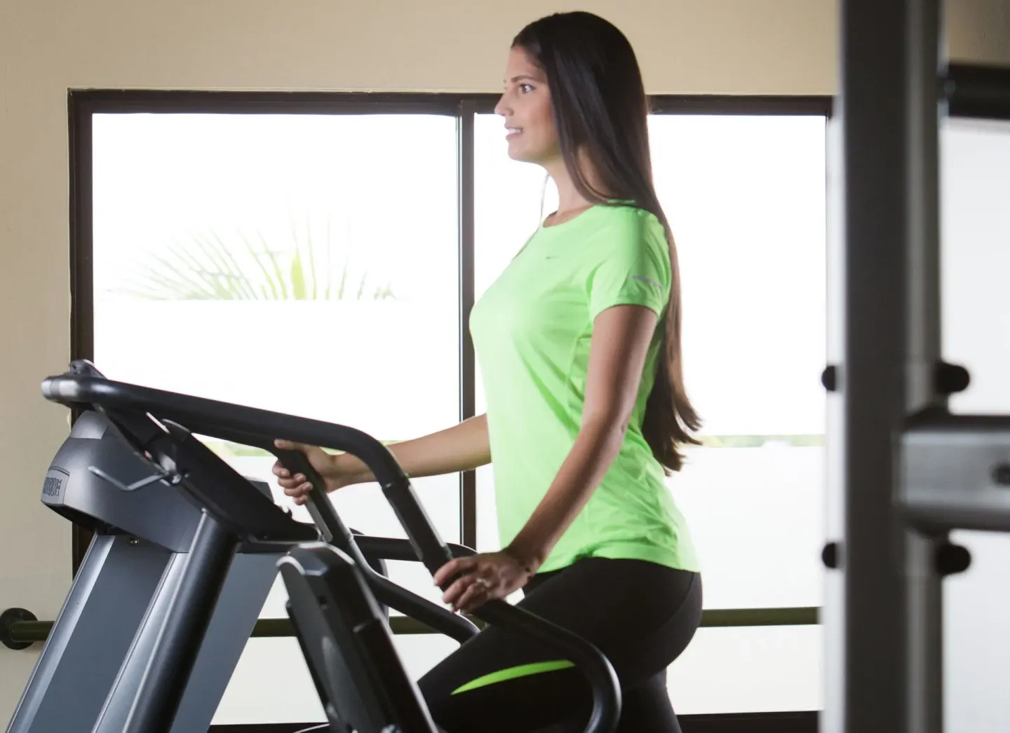 Guest uses an elliptical machine at Hodelpa Garden Suites Golf & Convention Center.
